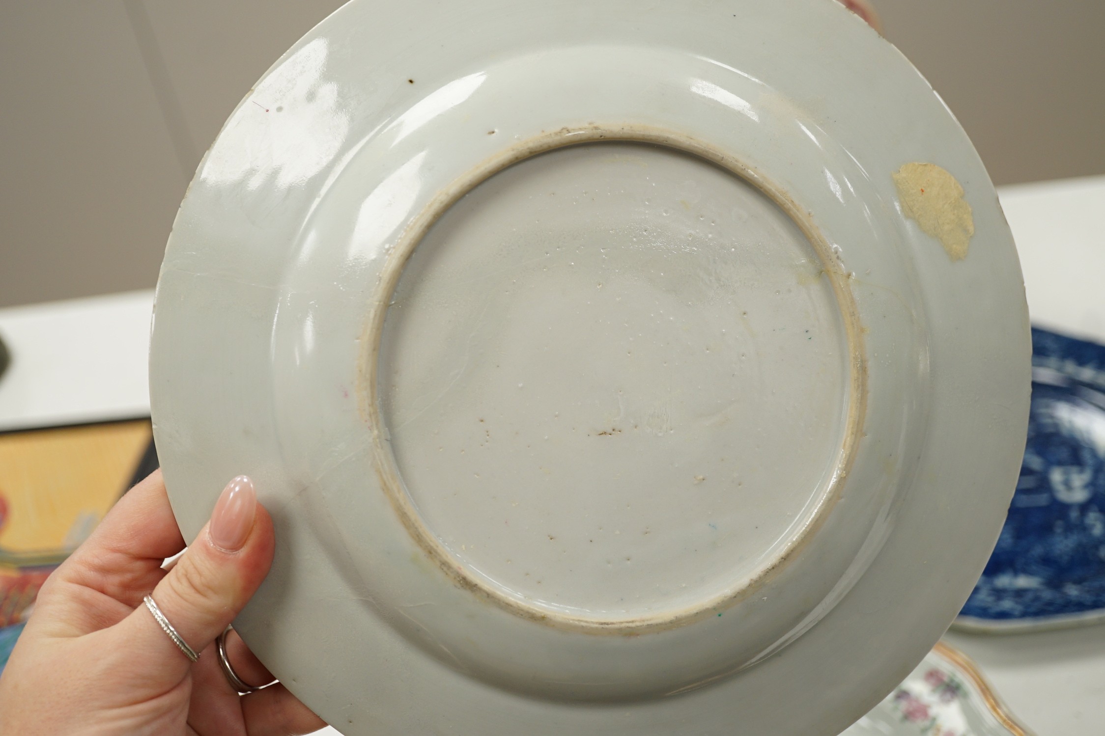 A Chinese export armorial soup plate, for the Spanish market, Qianlong period, with a Spanish coat of arms, possibly Aguado de Las Marismas, an 18th century Chinese export punch bowl on stand, a Chinese blue and white pl